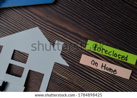 Foreclosed on Home text write on sticky notes isolated on office desk.
