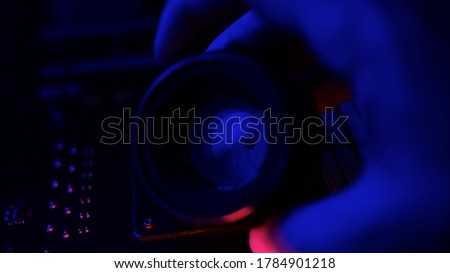 Excellent manual camera lens within blue and pink lights, iris adjusted by hand