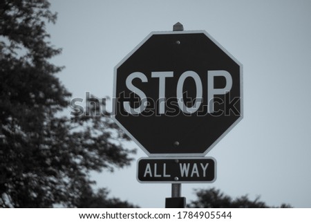 mysterious black and white stop sign