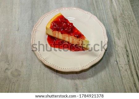 Cheesecake with strawberry sauce on top.