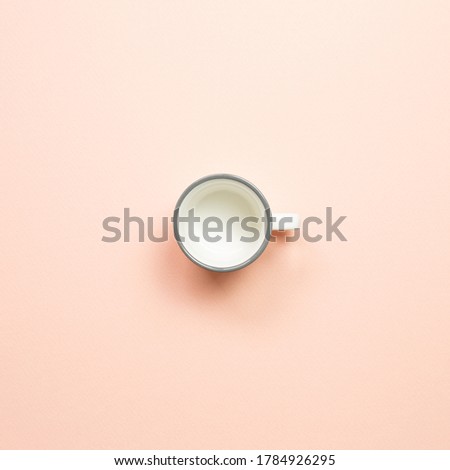 White empty mug cup on pink background. top view