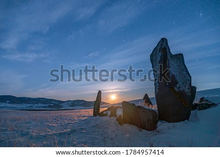Amazing night sky, natural outdoor travel background. Beauty world. Ancient menhir granite stones at night. Khakasia. Russia. Royalty-Free Stock Photo #1784957414