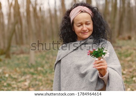 Woman in a forest.Woman with bouquet of flowers.