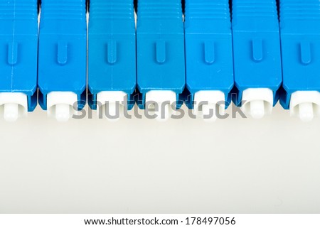 blue fiber optic SC connectors with reflection isolated on white background