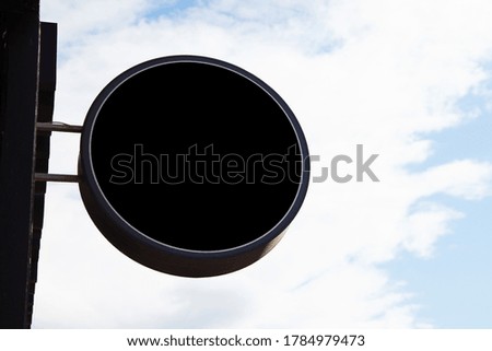 Round sign in black on the street, copy space