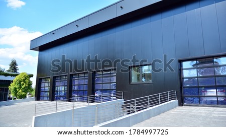 Facade of a modern navy blue warehouse