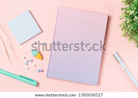flat lay stationery on work desk in pink pastel background