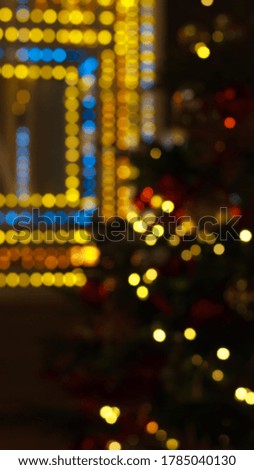 Colorful bokeh defocused Christmas garlands, Christmas market. Festive abstract background. The vertical format.
