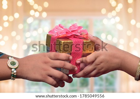raksha bandhan (rakhi, rakshabandhan) concept. Indian brother giving gift to his sister