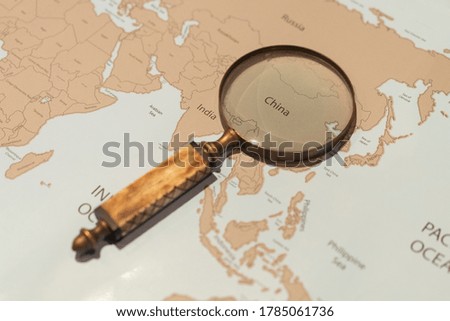 magnifying glass over world map
