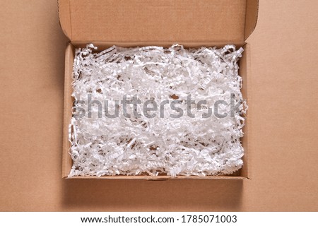 White paper filler in cardboard box Royalty-Free Stock Photo #1785071003