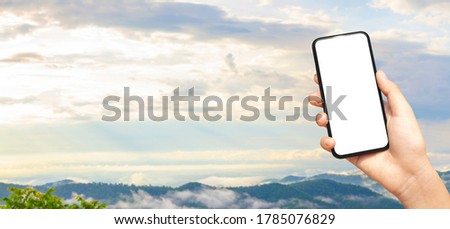 beautiful female hand holding smart phone with black screen against nature moutain with clound background, technology and nature concept. banner and copy space