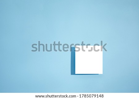 White empty blank card mockup on blue background. top view