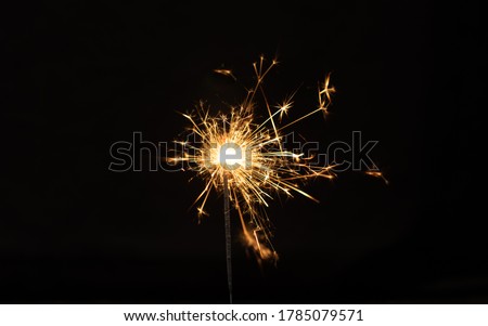 Sparkler background. Christmas and new year sparkler holiday background. bengal light on the black background