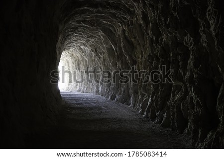 Deep stone tunnel, detail of ancient cave on a mountain Royalty-Free Stock Photo #1785083414