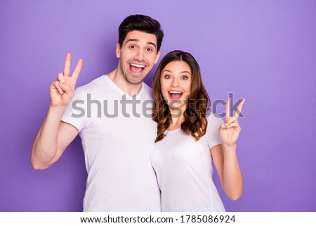 Portrait of energetic lovely spouses enjoy summer rest relax make v-sign enjoy rejoice wear good look clothes isolated over purple color background