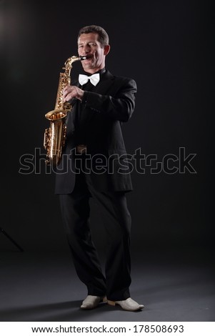 Adult man playing the saxophone
