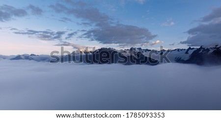 Cloud inversion over the Franz Josef valley with most of Franz Josef Glacier obscured by the clouds. After sunset, at dusk, from the view of the summit of Alex Knob. Franz Josef Glacier, New Zealand