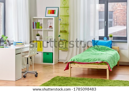 interior, home and furnishing concept - kid's room interior with bed, table and bookcase