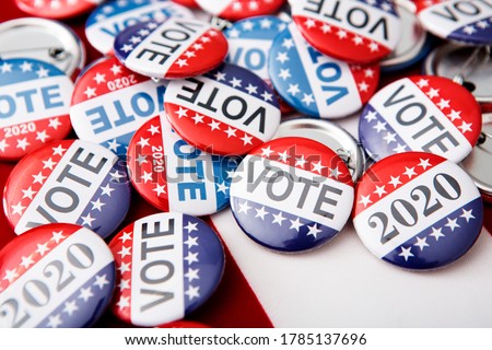 2020 election campaign pins on American flag, vote button for voters Royalty-Free Stock Photo #1785137696