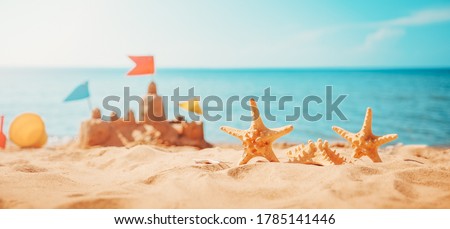 Sandcastle on the beach at sea in summertime Royalty-Free Stock Photo #1785141446