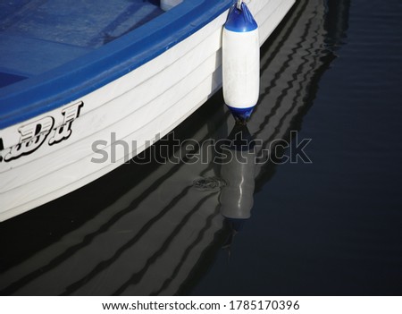 
fishing boat reflection in the water