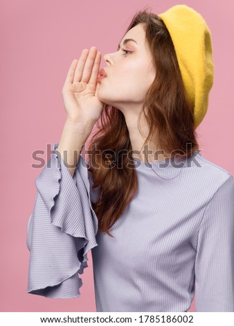 Pink background yellow hat Light shirt fashionable woman