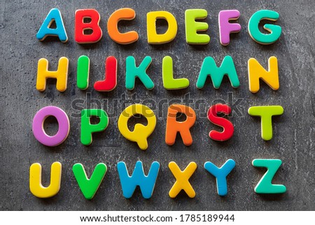 Colorful letters on granite background, alphabetical order, top view