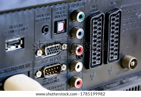 Rear panel of a television with sockets for audio / video, scart connections and for rgb video input for the monitor. Technology and connections between devices Royalty-Free Stock Photo #1785199982