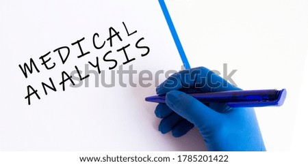 Female doctor's hand in a medical glove makes an inscription in a document. Medical concept.