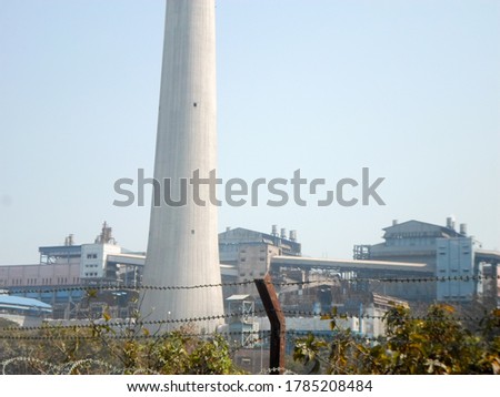 Factory chimney, industrial smoke chimneys, Tall industrial factory chimney smokestacks of jute mill industry in Ganges riverside of Kolkata West Bengal India South Asia Pacific Royalty-Free Stock Photo #1785208484