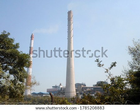 Factory chimney, industrial smoke chimneys, Tall industrial factory chimney smokestacks of jute mill industry in Ganges riverside of Kolkata West Bengal India South Asia Pacific Royalty-Free Stock Photo #1785208883
