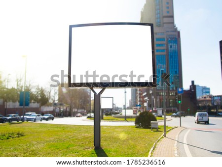Horizontal white, blank billboard in the city. Billboard template for mock up located in the sunny city view.