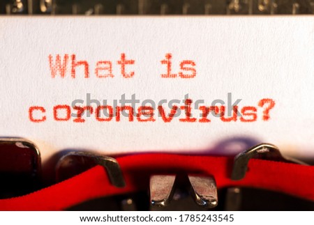 "What is coronavirus ?" on typewriter on red. Asking for information about the covid concept