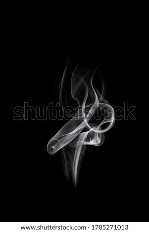 Abstract white smoke or steam swirls on black background