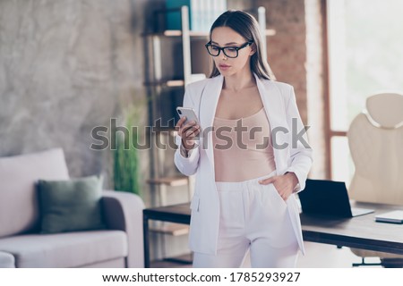 Portrait of attractive classy chic focused busy lady qualified partner using device translation agency owner communicating clients modern industrial loft brick interior workplace workstation Royalty-Free Stock Photo #1785293927