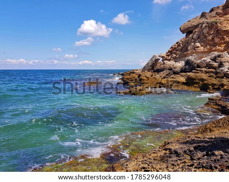 Crimea. The turquoise sea beats against the rocks.