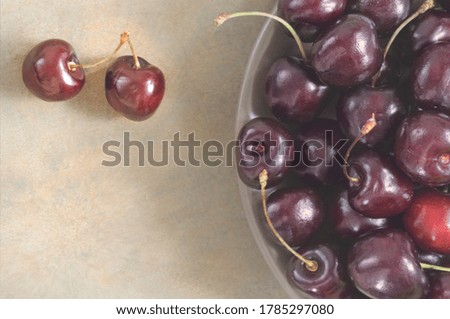 Ripe cherries on a plate. Part. Free space for text. Selective soft focus