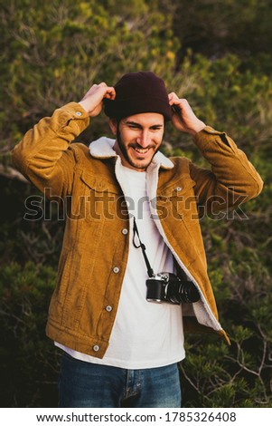 Portrait Of Young Man Carrying Camera outdoors