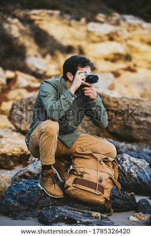 Portrait of young Man taking pictures outdoors