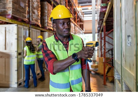 Portrait of african black warehouse worker hold hand scanner to do inventory work stock in distribution warehouse. Traceability FIFO LIFO inventory just in time and warehouse concept photo.