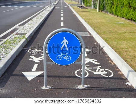 Straight two way cycle lane with traffic street signs. 