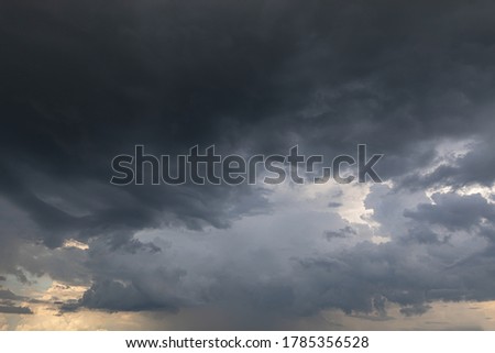 Nature background with stormy clouds. Dark dramatic sky with a stormy gray clouds before the rain