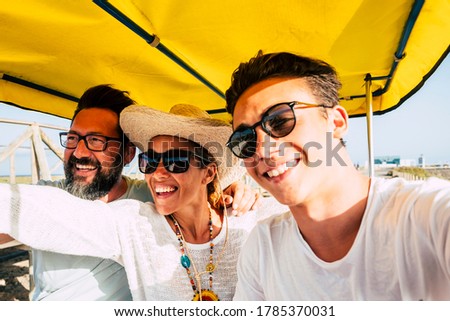 Cheerful happy family have fun together in outdoor leisure activity laughing and smiling - concep tof summer holiday vacation for adult and teenager people - selfie style picture for social media