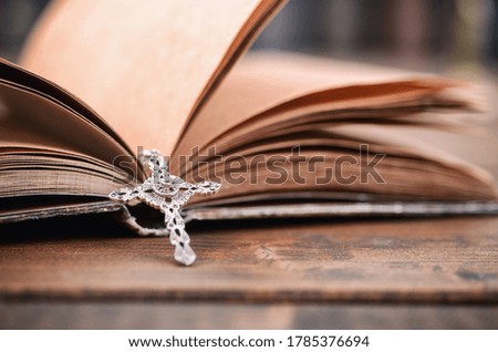 Christian cross necklace on a Holy Bible, Christianity and Religion concept.