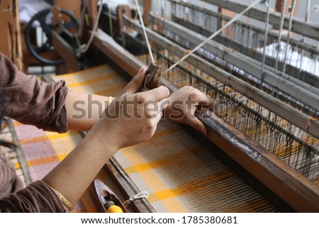 Handloom weaver in India working in her loom Royalty-Free Stock Photo #1785380681