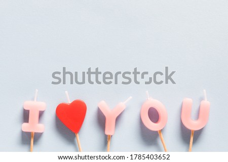 I Love You candles on pastel blue background. Valentines day concept background. 