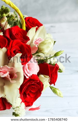 Bouquet of beautiful flowers with red roses and eustomas on gray background. Closeup picture. Valentine's Day. Mothers Day card