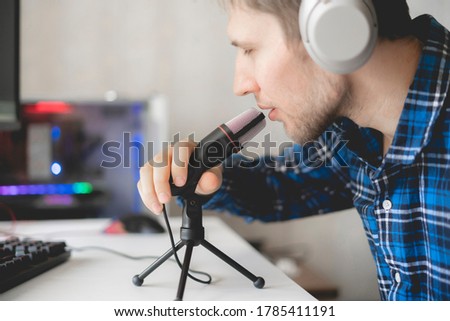 young male handsome host recording podcast in the studio, streaming live 