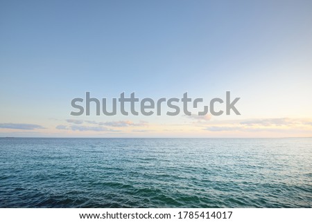 Sunset sky reflecting in the water, aerial view from the sandy shore. Setting sun. Abstract art, natural pattern. Baltic sea, Sweden. Idyllic seascape. Travel destinations, vacations concept Royalty-Free Stock Photo #1785414017